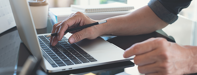 Businessman focused on learning how to increase laptop speed for better performance