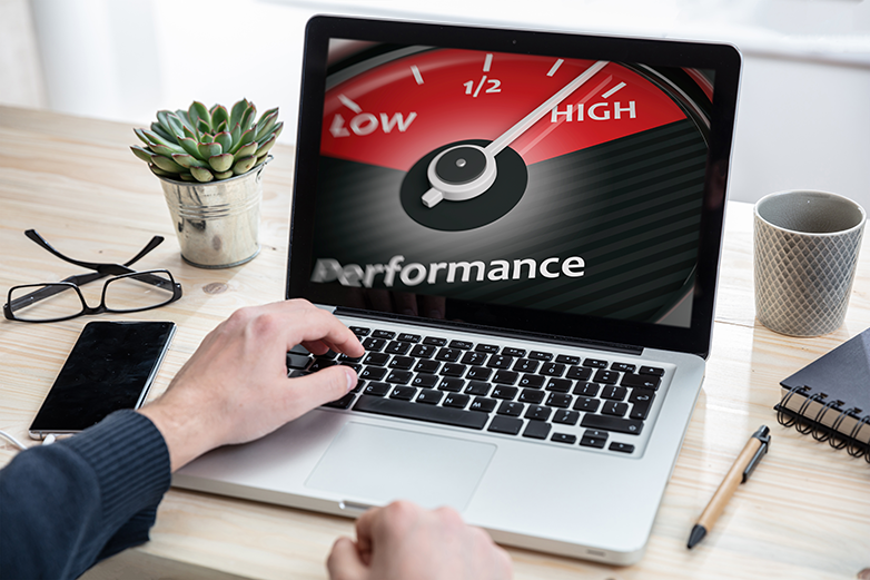 Man working with a computer in an office after performing a "how fast is my computer" test. High-Performance on computer screen.